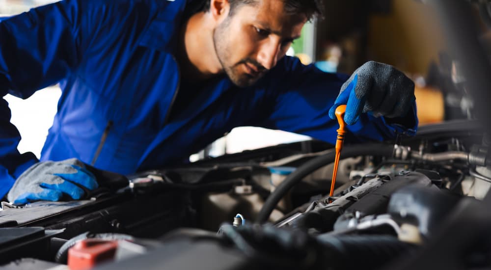 Mechanic working on an oil change near Magnolia