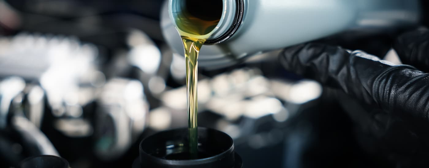 Oil pouring out of a bottle into an engine