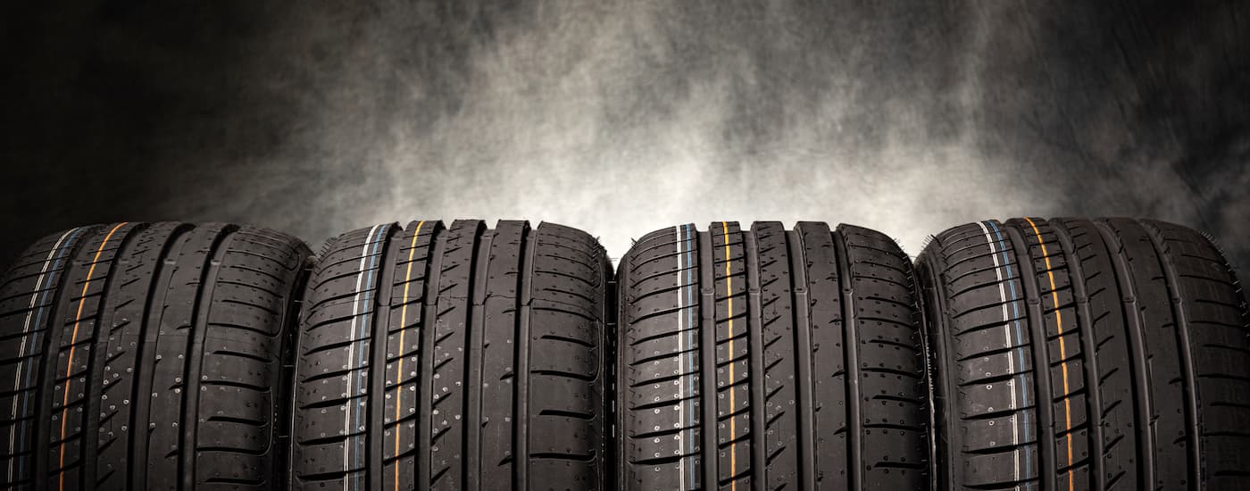 Row of tires at a shop that perform wheel alignment near Jersey Village