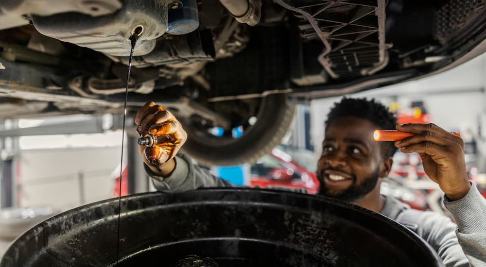 Man performing an oil change at an express oil change and service center near Pinehurst