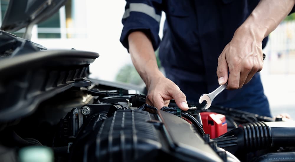 Mechanic working on a vehicle's engine during auto repair in Tomball