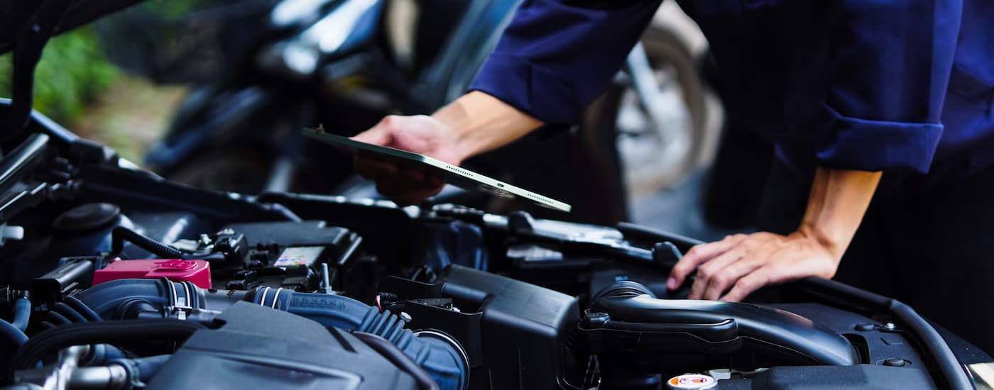 Mechanic inspecting a vehicle's engine