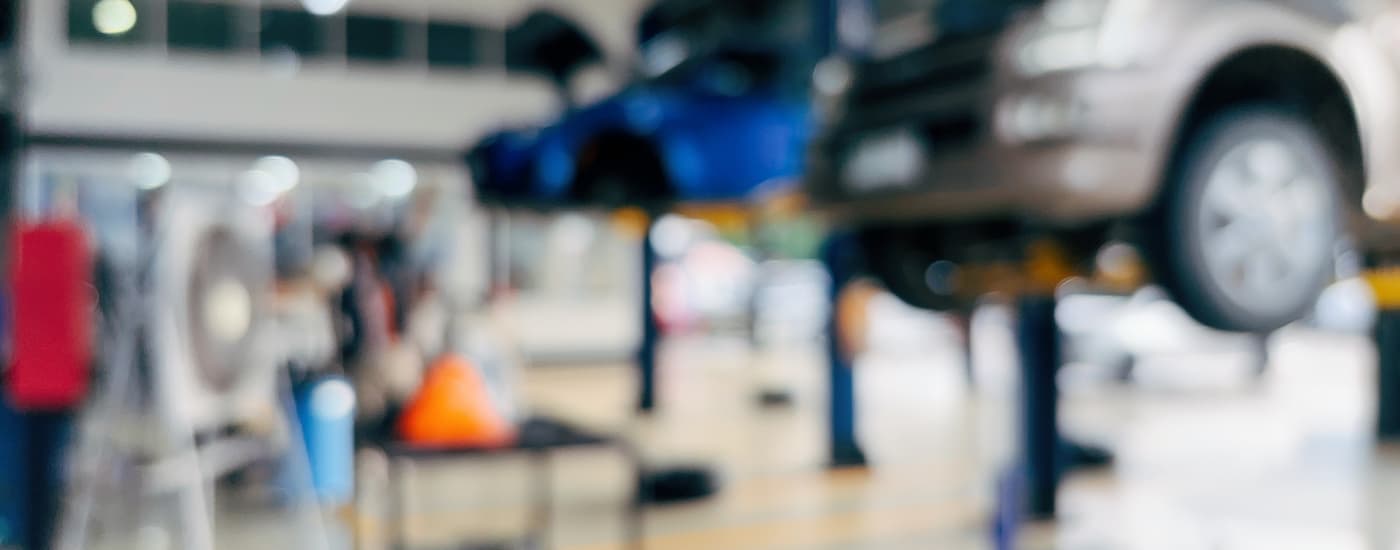 Vehicles on lifts inside of a service center