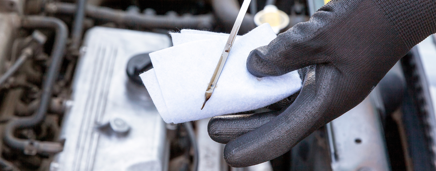 Close-up on an oil wick being wiped off.