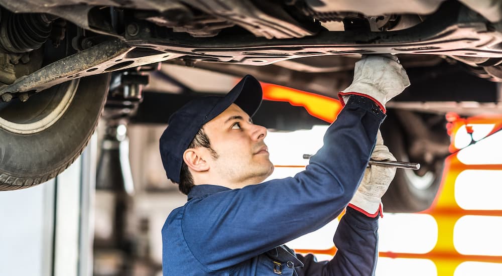 A mechanic changing the oil in a vehicle