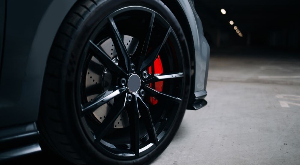 A black rim and tire on a vehicle