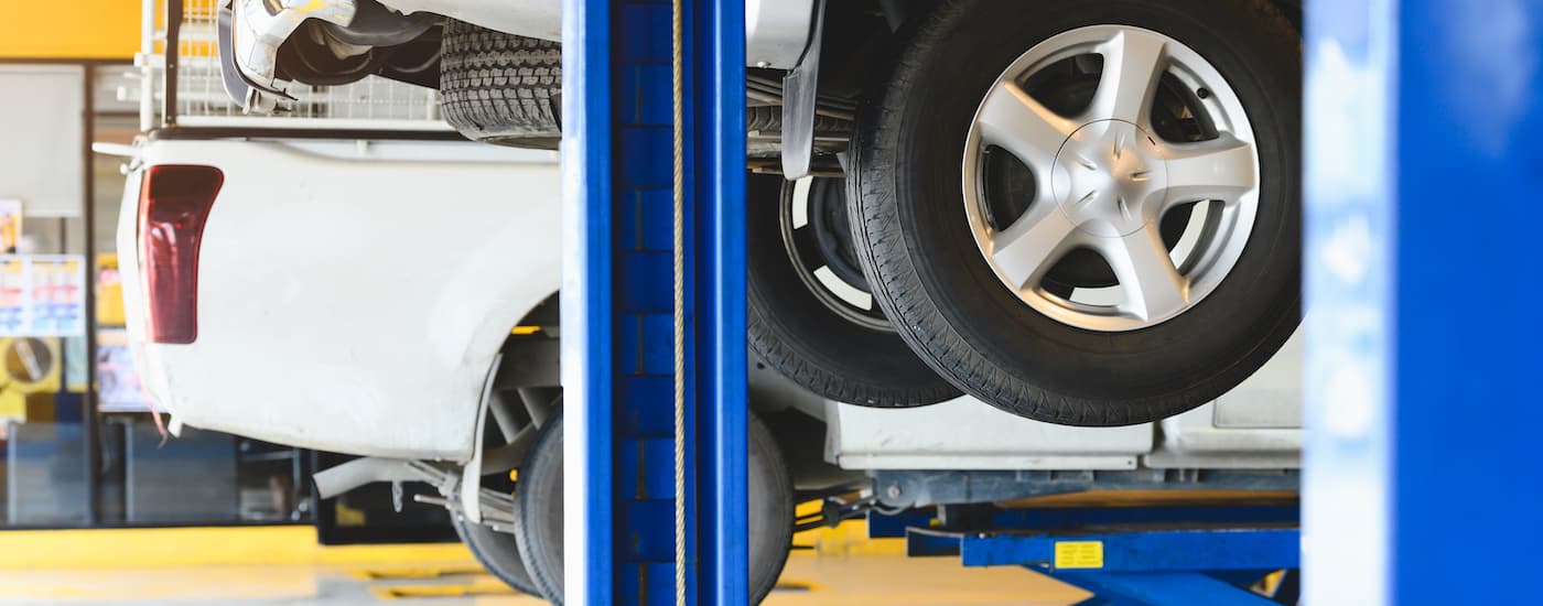 A car on a vehicle lift in a shop