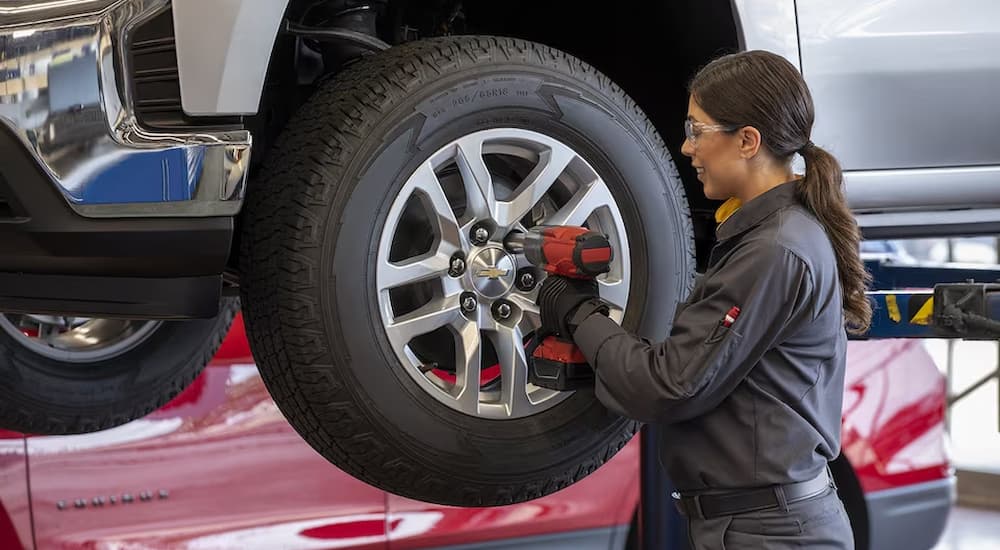 A technician installing a tire.